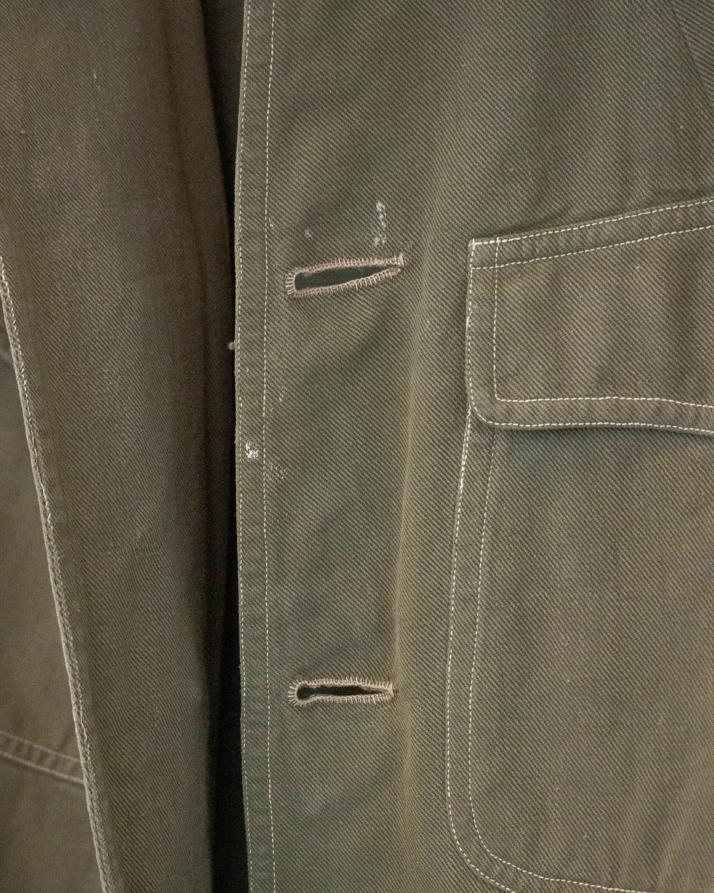 Button holes on green jacket