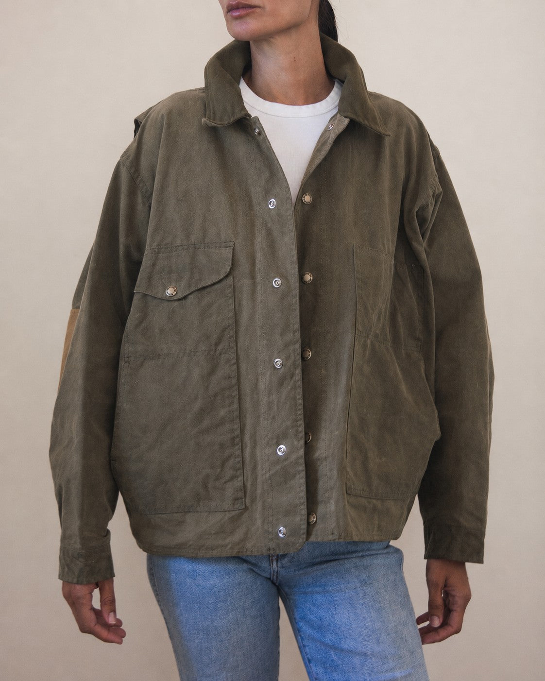 Woman wearing oversized olive green jacket