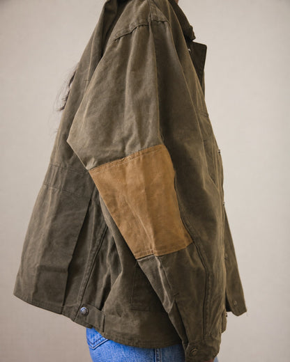 Tan elbow patch on oversized olive green jacket