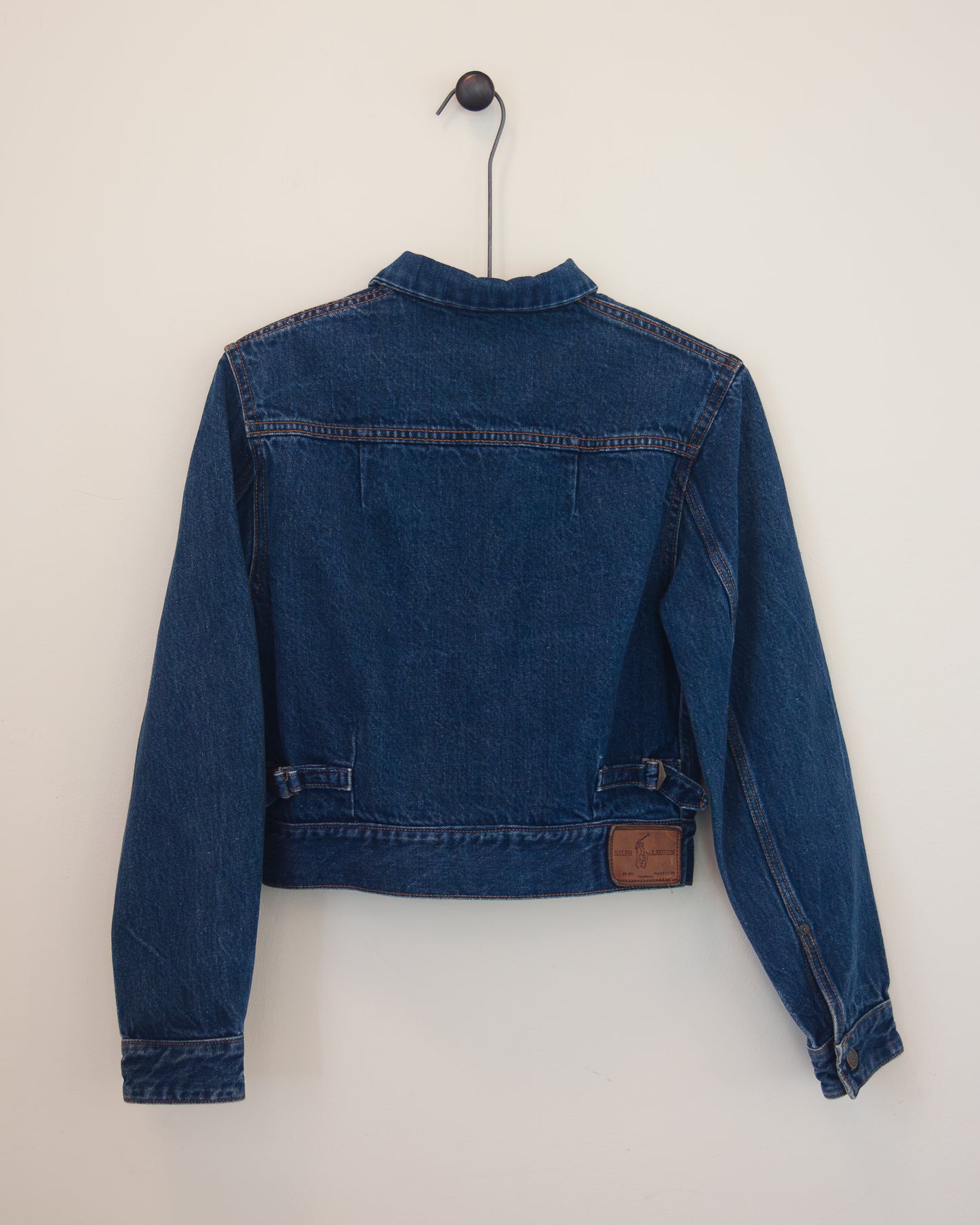 Back of denim jacket on hanger