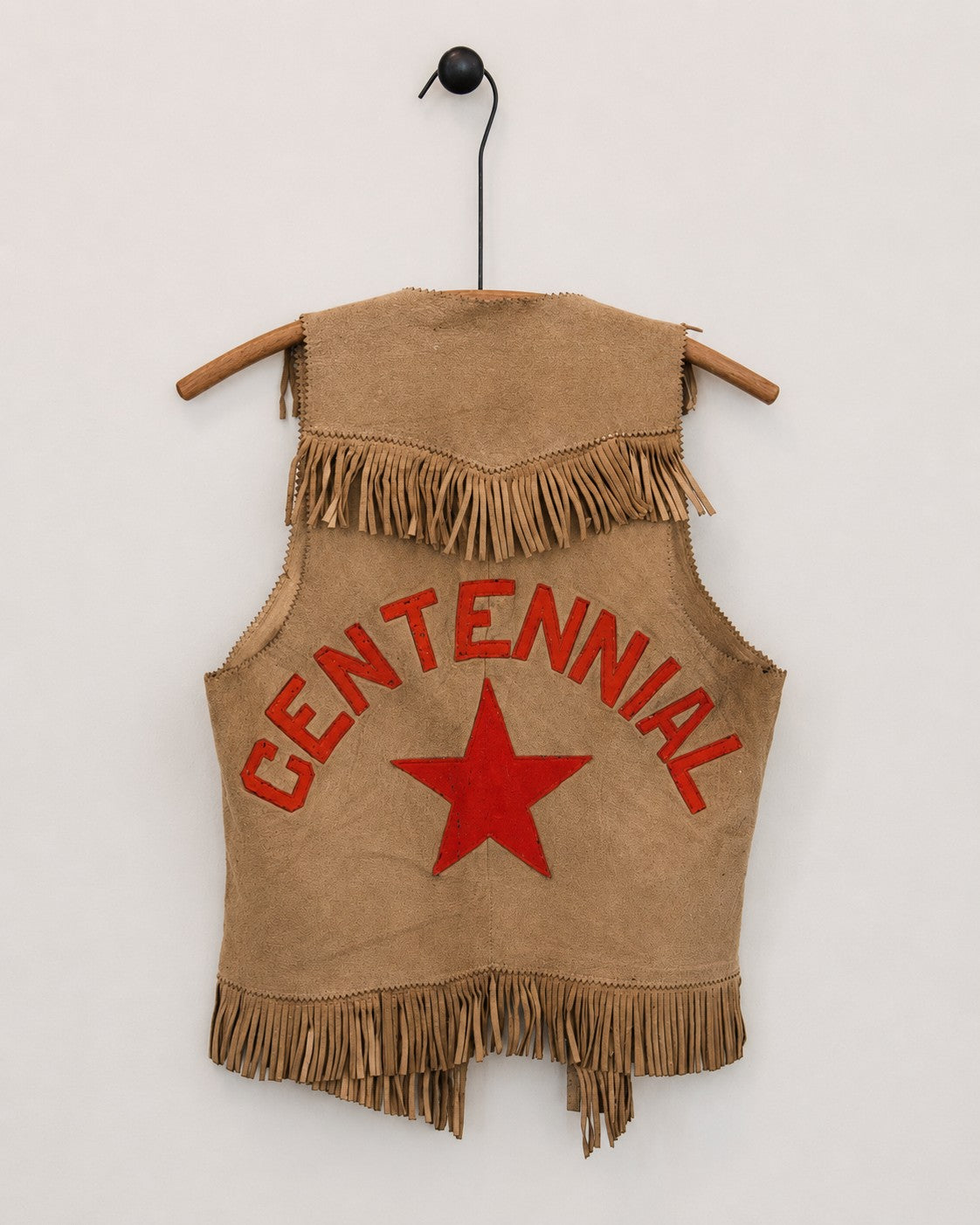 Back of suede leather vest on hanger with orange CENTENNIAL and star graphics on back