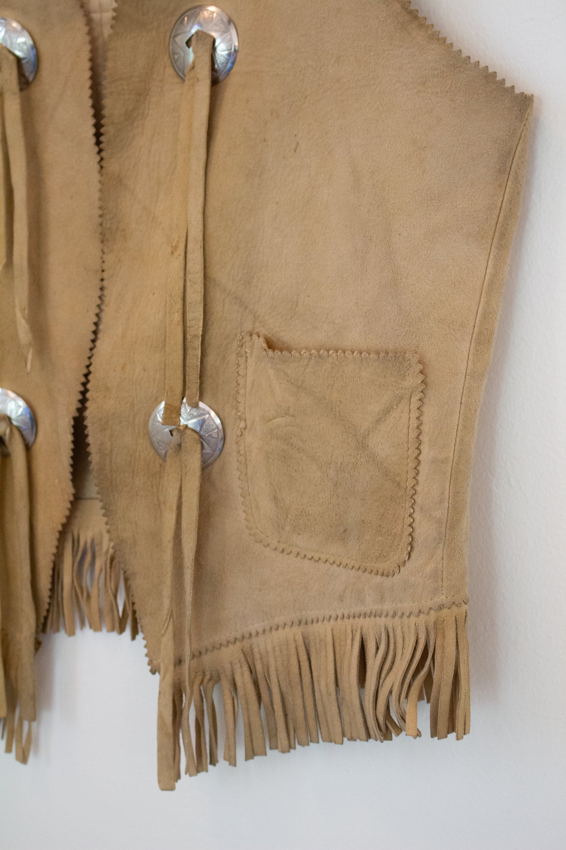 Buttons and pocket on suede leather vest
