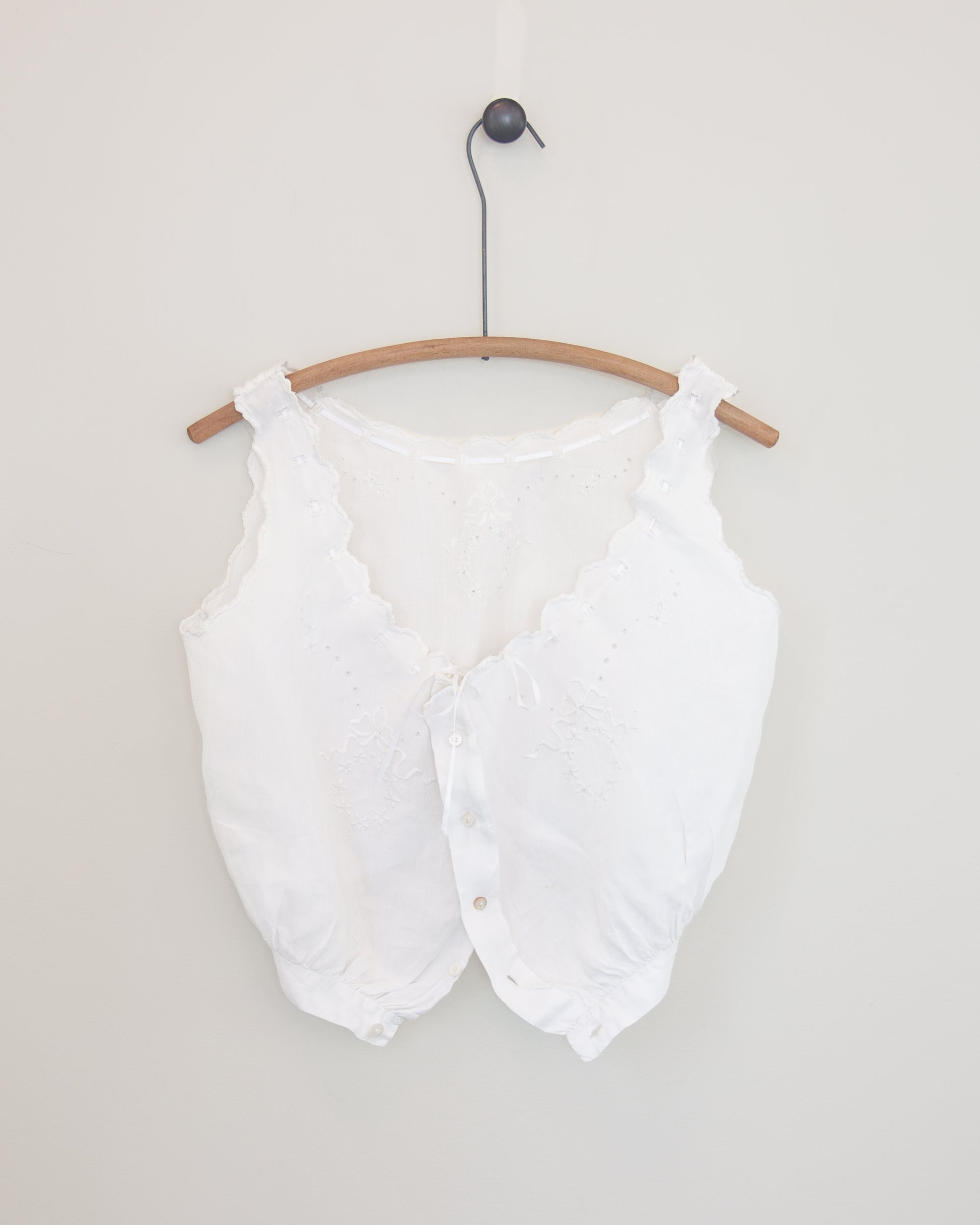 White corset cover on hanger
