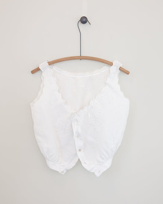 White corset cover on hanger