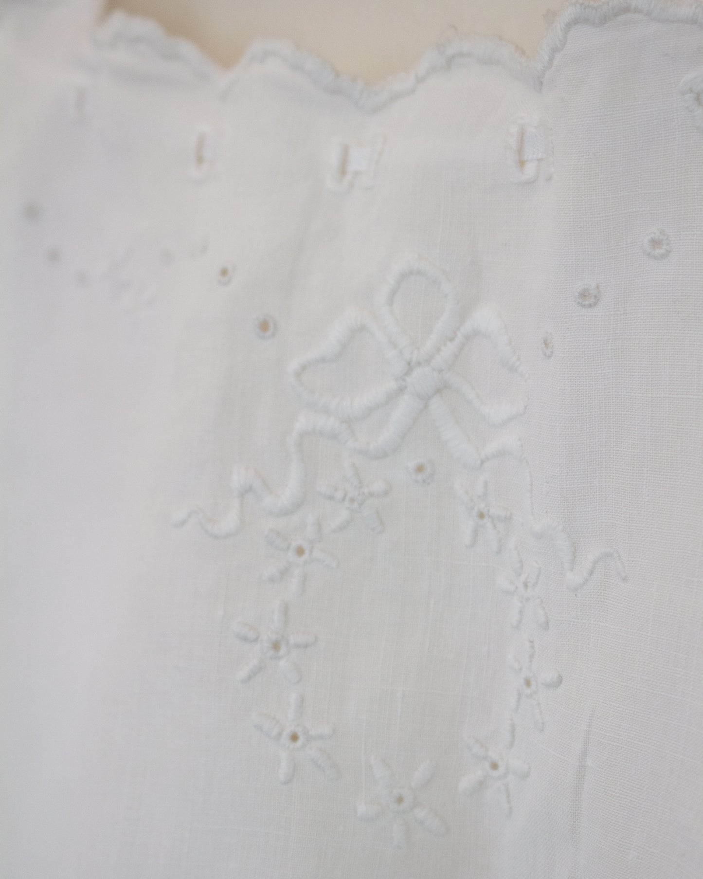 Close up of wreath embroidery on white shirt