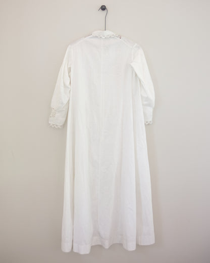 Back of white dress with lace detailing on hanger