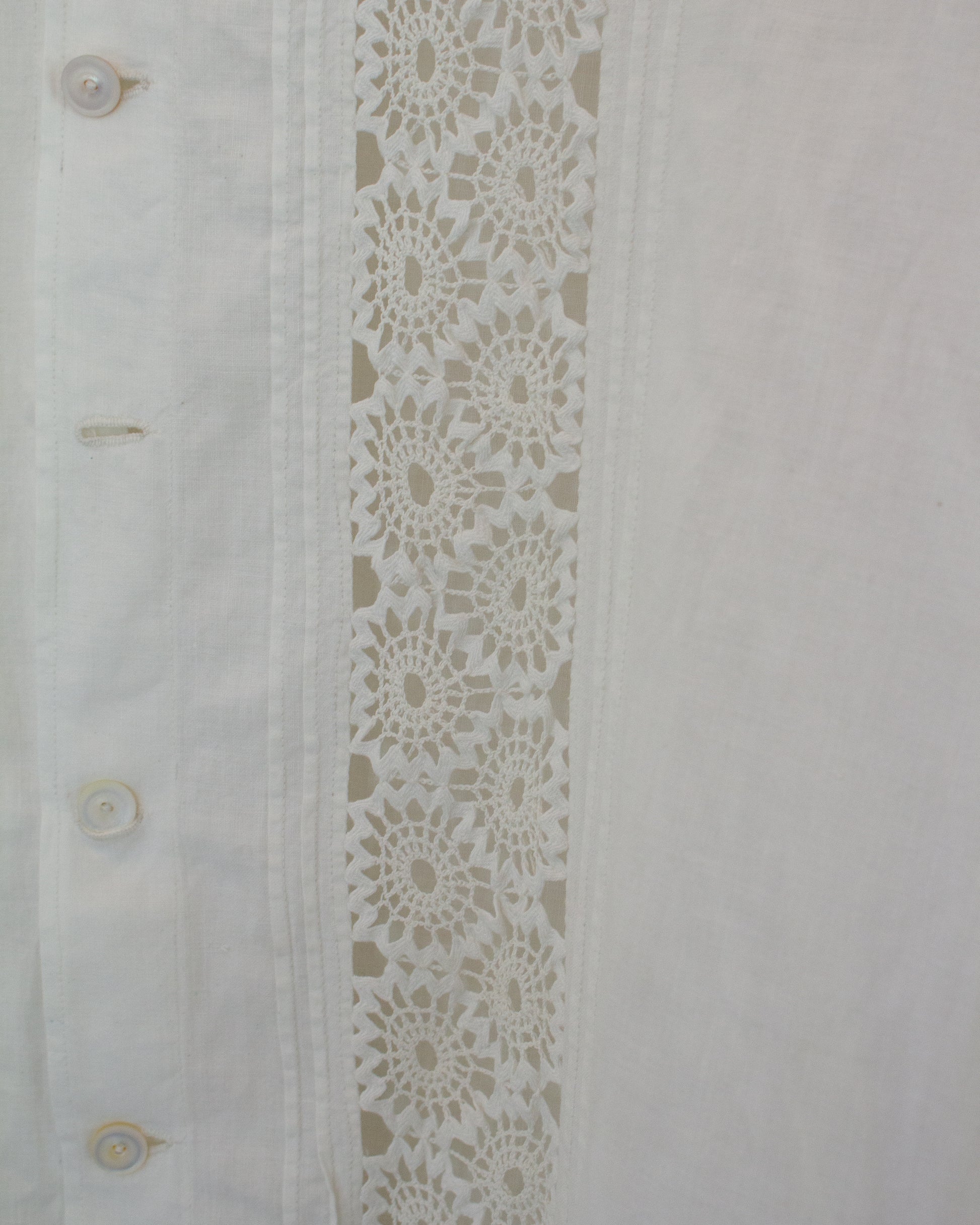 Close up of white dress with lace detailing