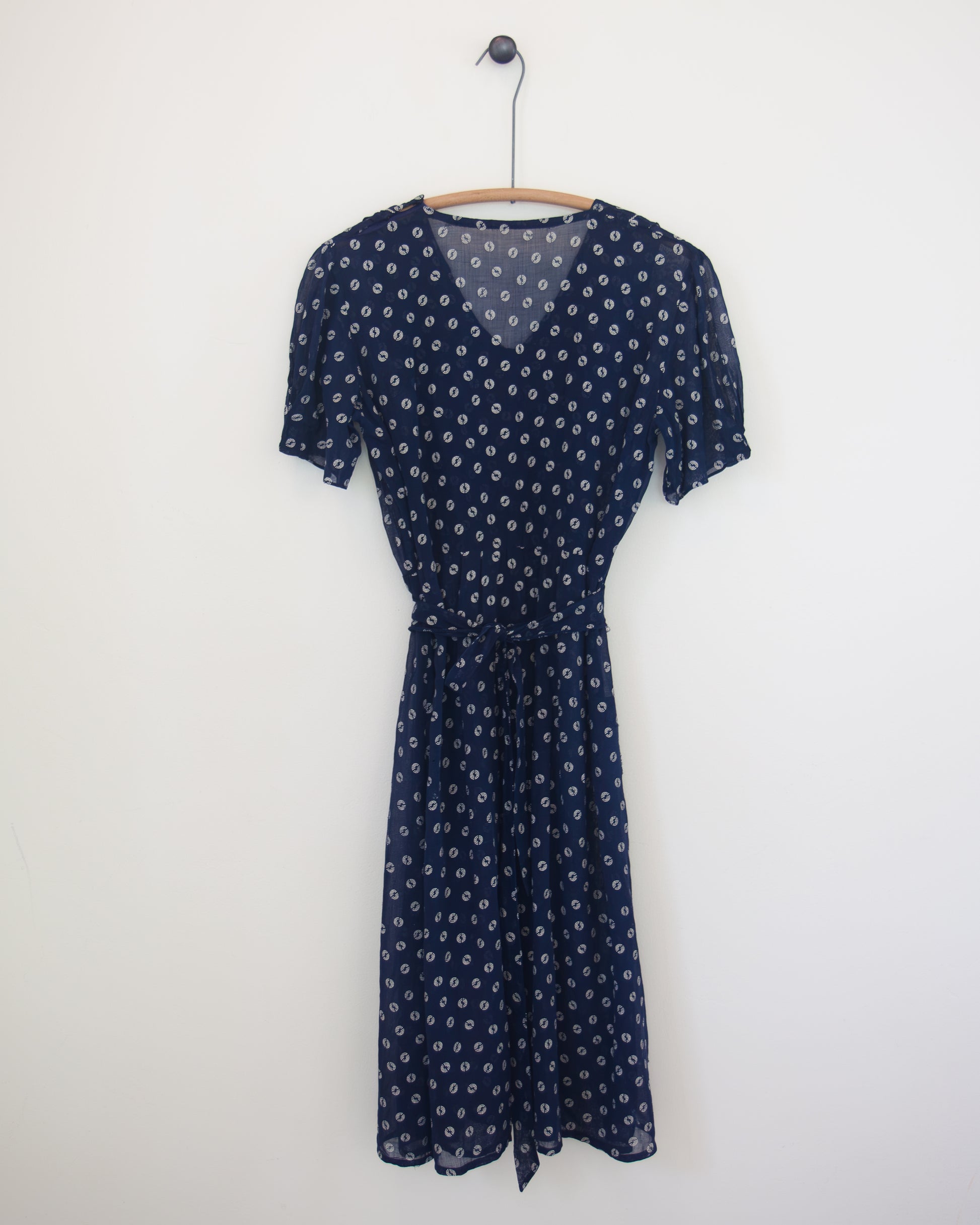 Back of blue and white dress on hanger