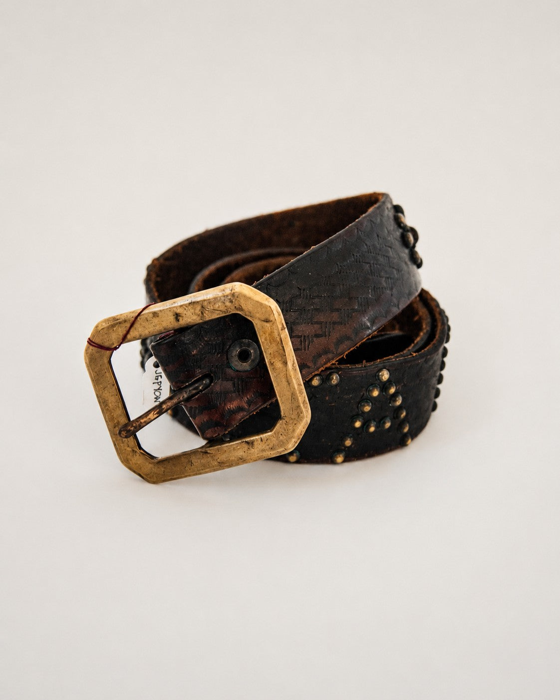 Close up view of brass buckle on leather belt