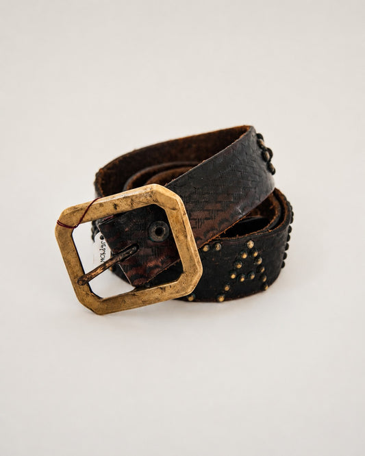 Close up view of brass buckle on leather belt