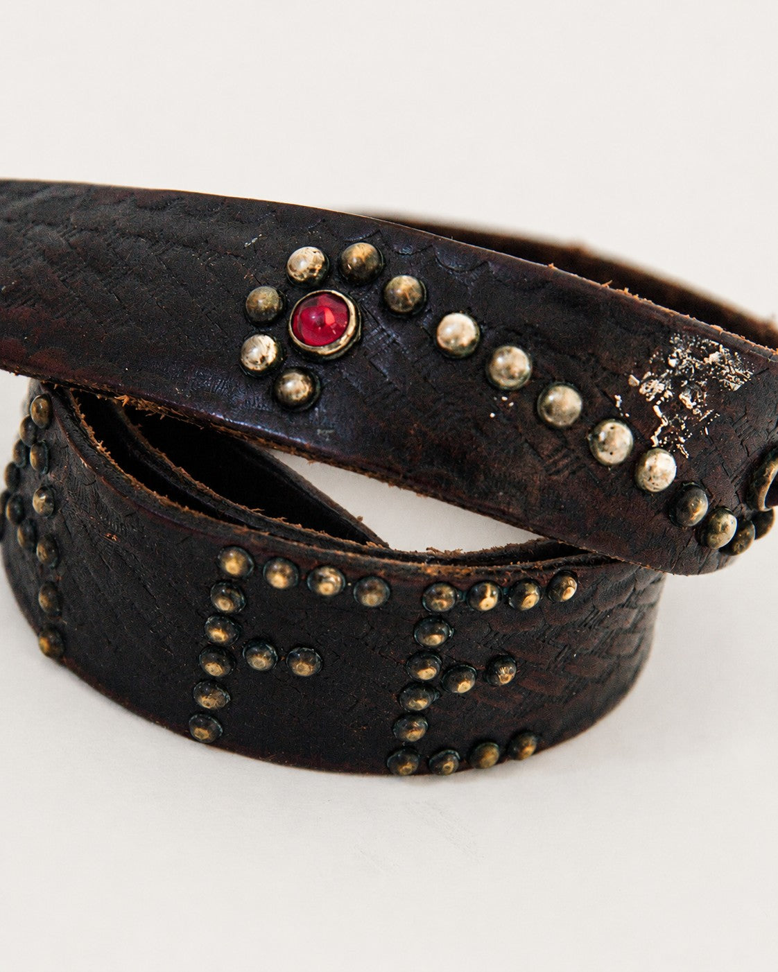 Close up view of studded and jeweled leather belt