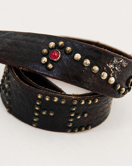 Close up view of studded and jeweled leather belt