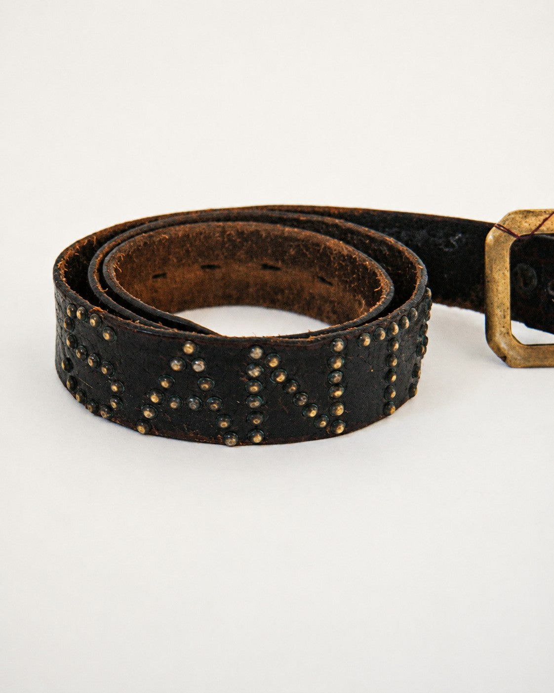 Close up view of studs on leather belt
