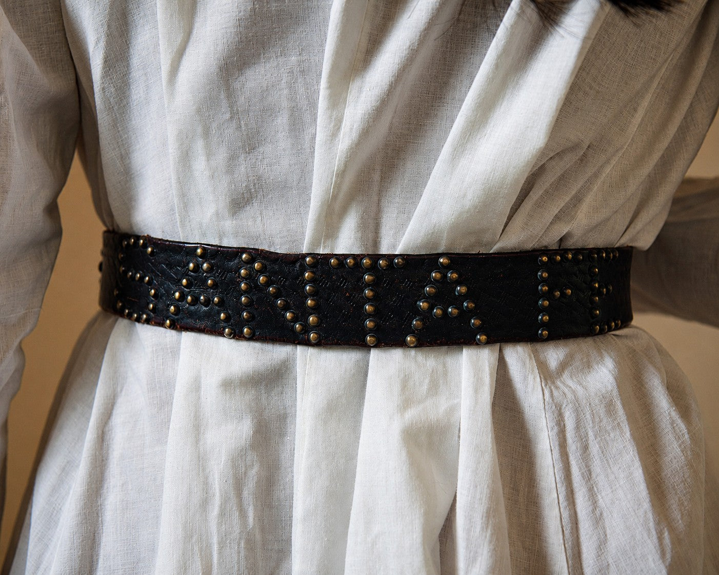 SANTA FE studded belt over white dress