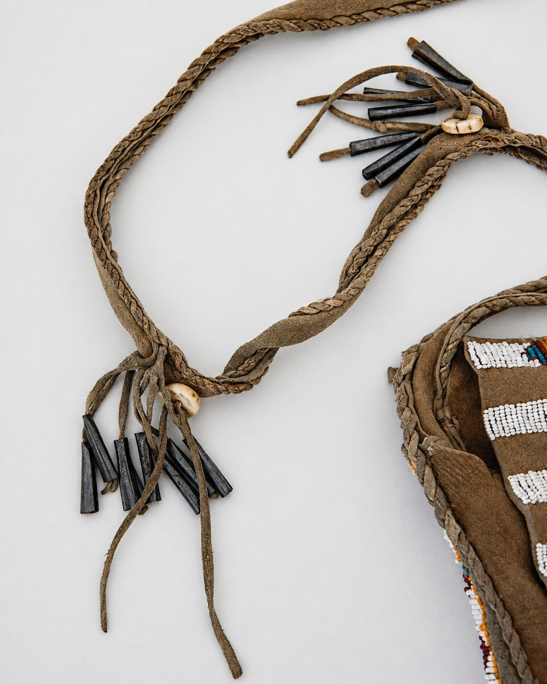 Fringe detail on crossbody strap of bag