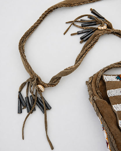 Fringe detail on crossbody strap of bag