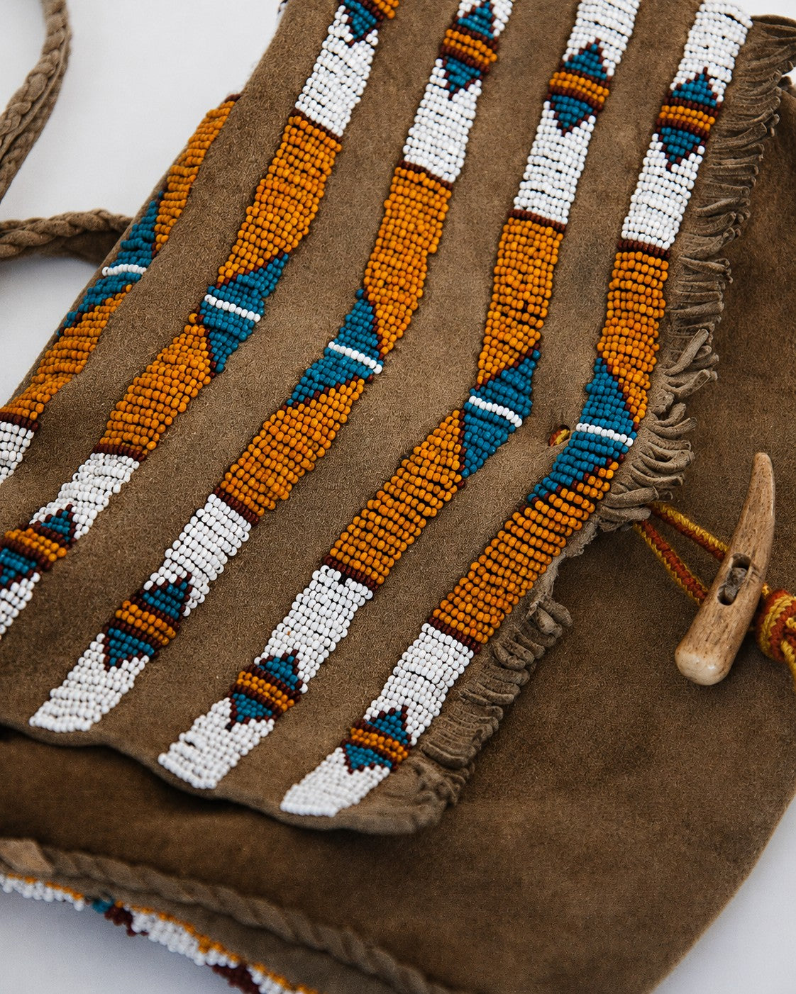 Close up of beaded leather purse with bone toggle closure