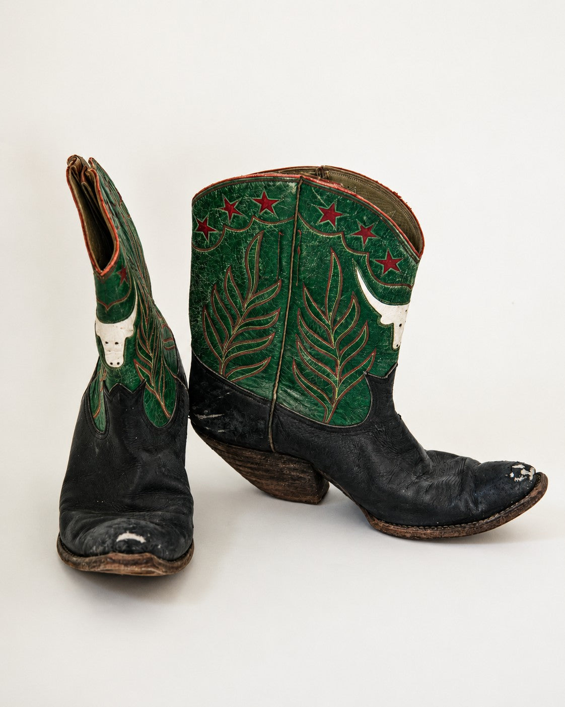 Black and green two-tone cowboy boots with longhorn and star inlay