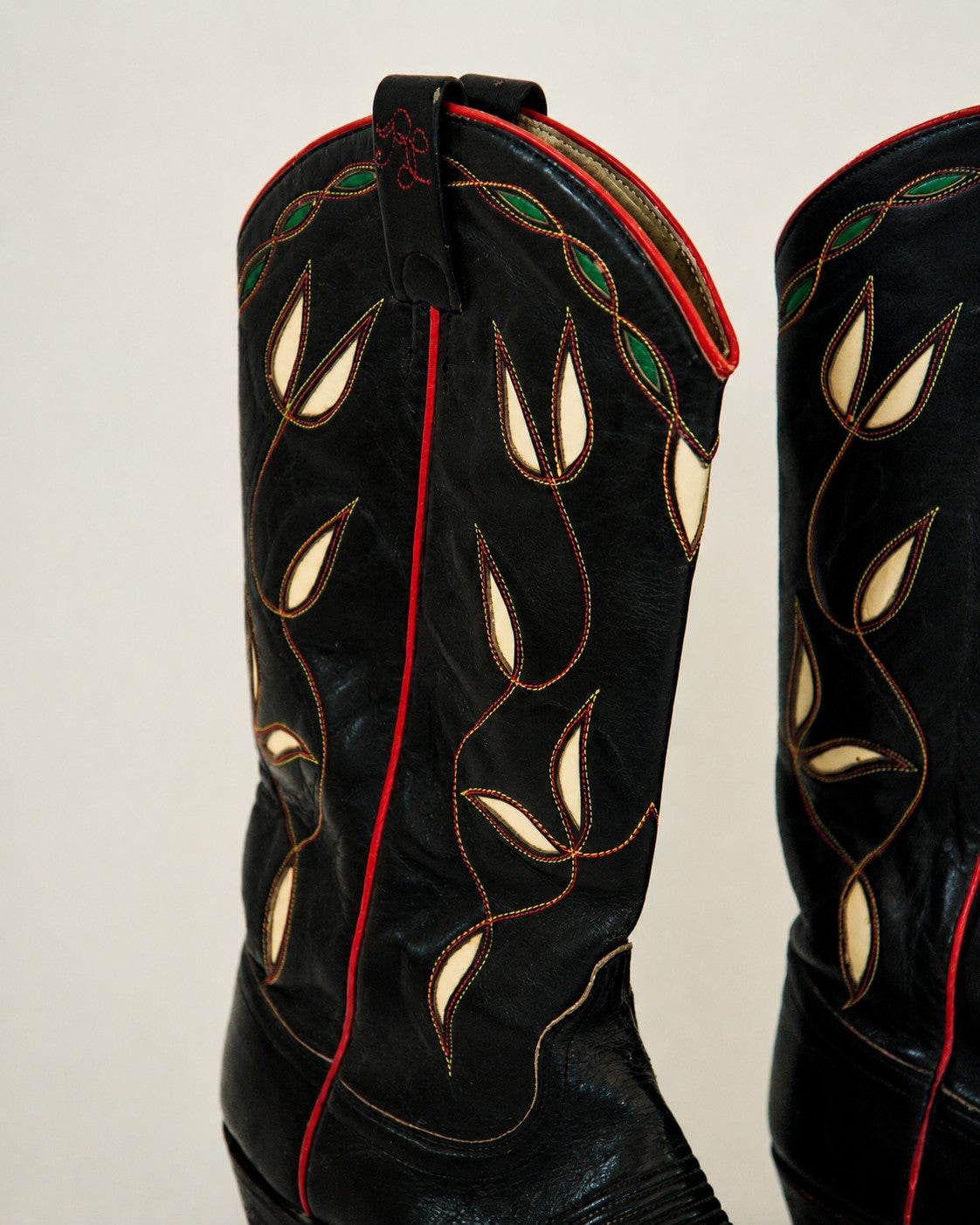 Close up of black cowboy boots with green/white inlay
