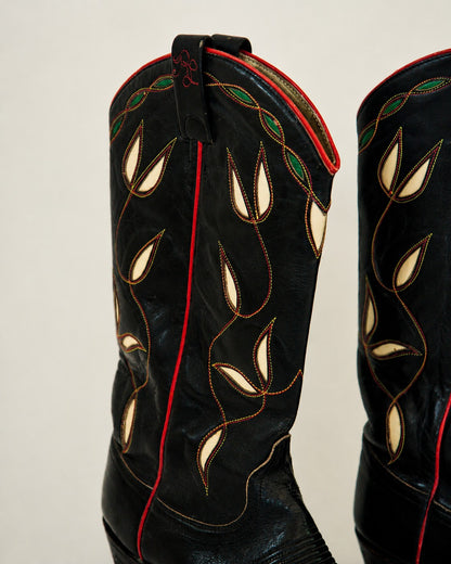 Close up of black cowboy boots with green/white inlay