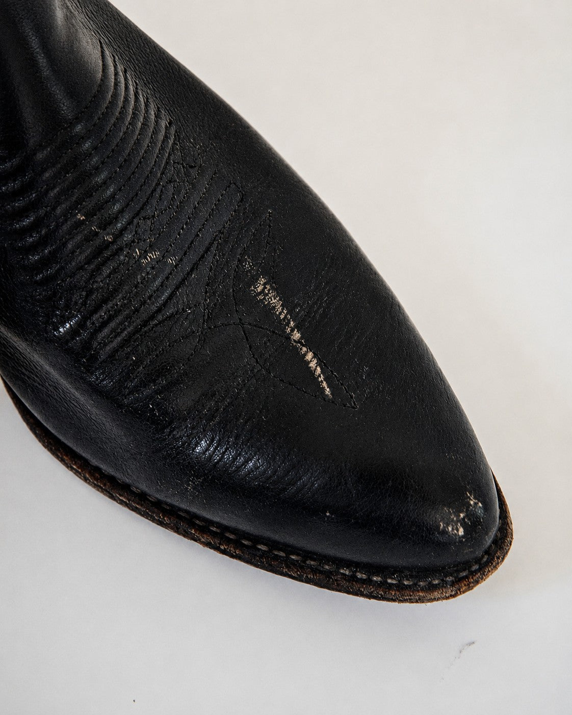 Scuffs on toe of cowboy boot