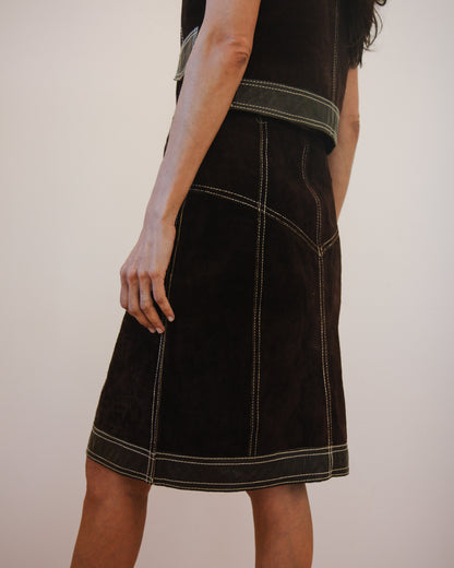 Back view of person wearing a brown leather skirt and vest set 