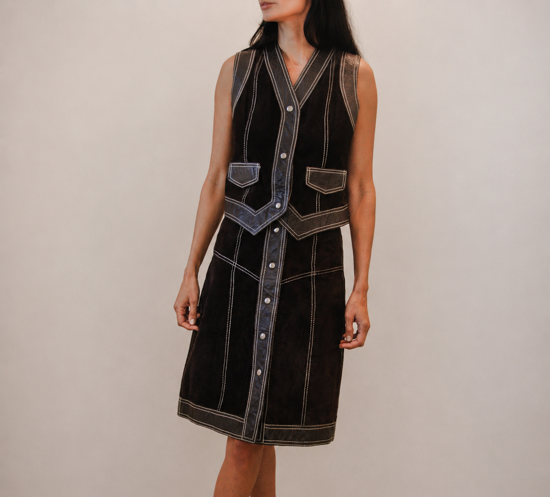 Person wearing a brown leather skirt and vest set 