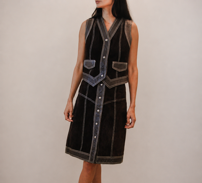 Person wearing a brown leather skirt and vest set 