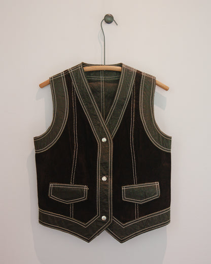 Brown leather vest with white stitching on a wooden hanger against a light gray background