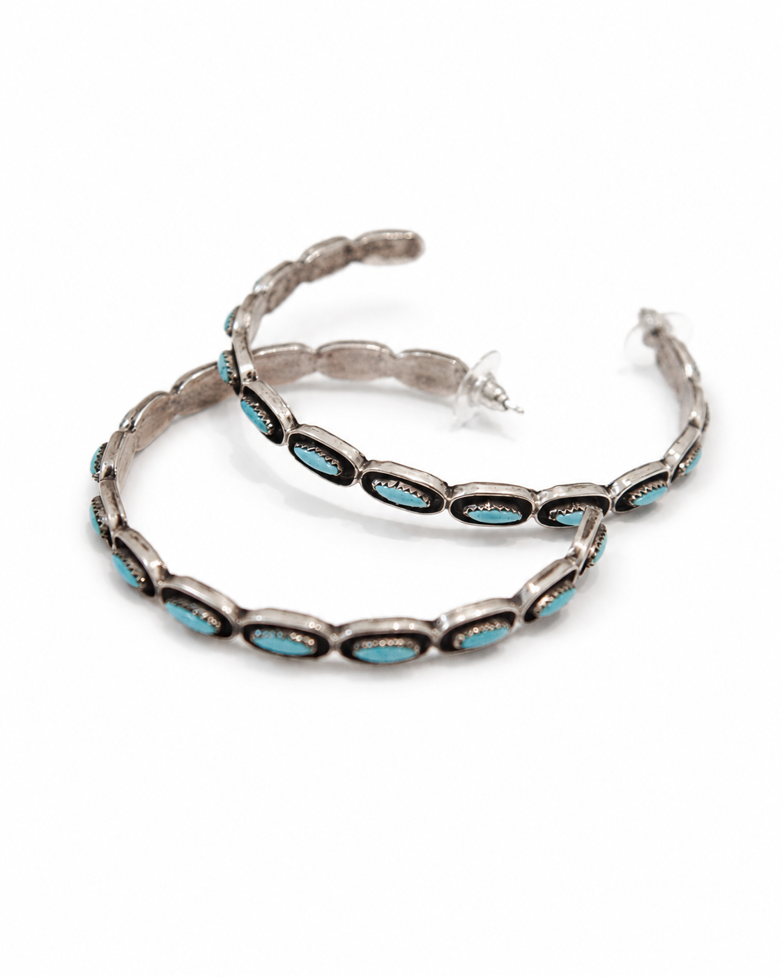 Pair of silver hoop earrings with turquoise stones on a white background