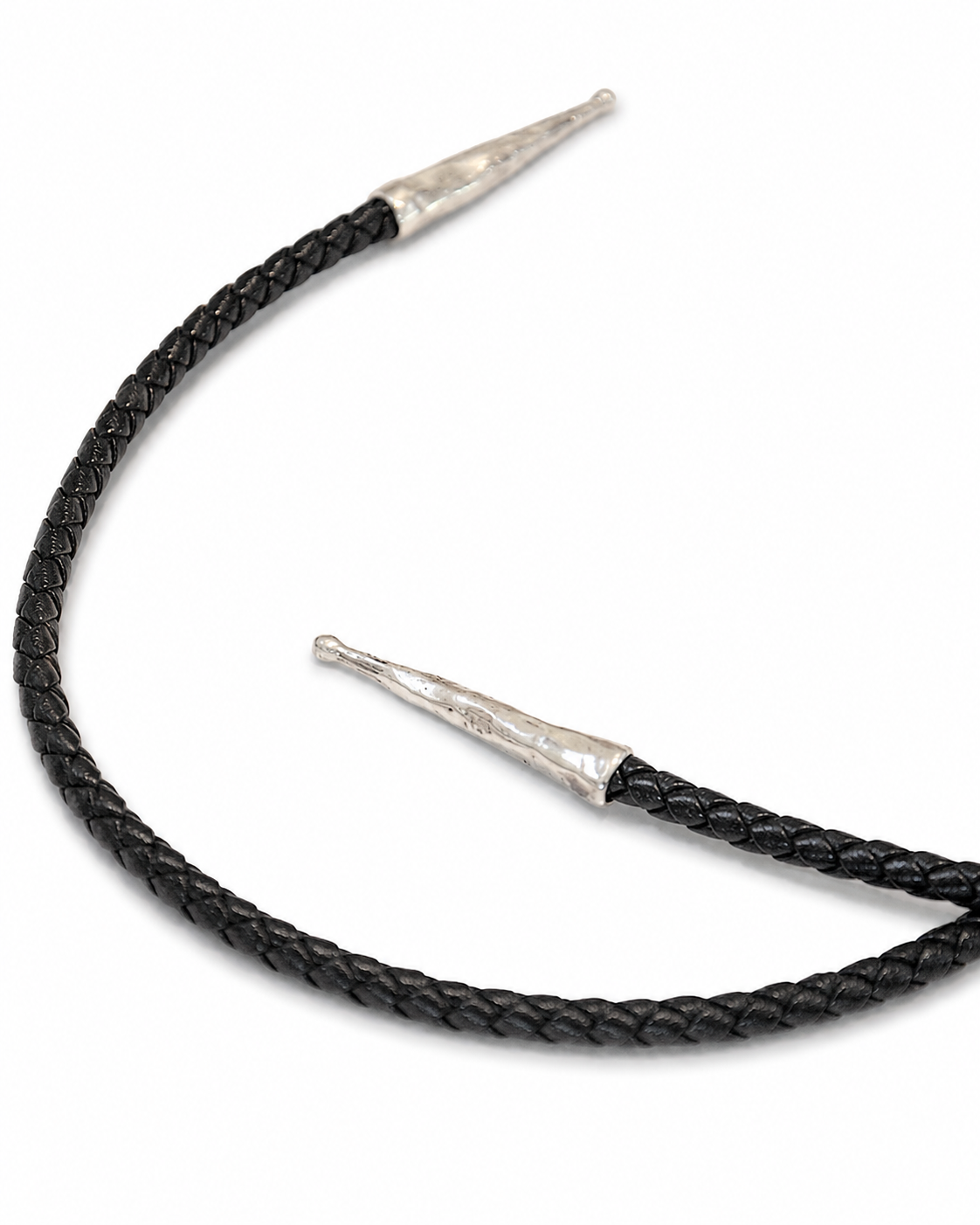 Black braided leather bolo tie with silver tips on a white background