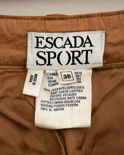 A close-up of a brown suede or suede-like fabric with Escada Sport tag.