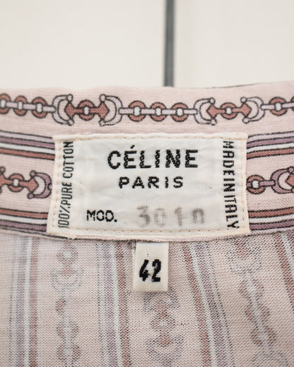 Close-up of a Céline Paris garment label on a light pink patterned textile, with a size tag reading 42.