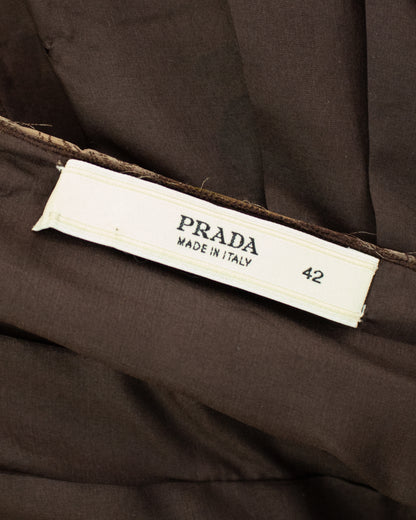 Close-up of a dark brown Prada garment interior with a white sewn-in size label reading PRADA MADE IN ITALY 42.