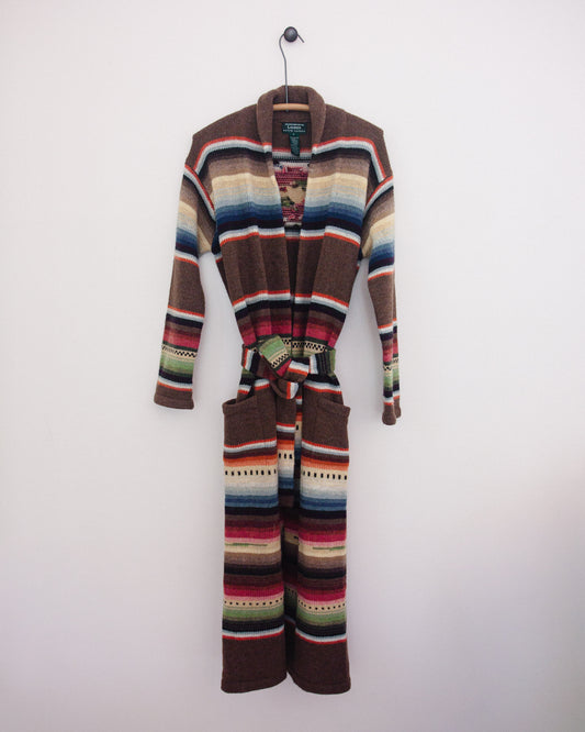 Multi colored cardigan with belt on hanger. 