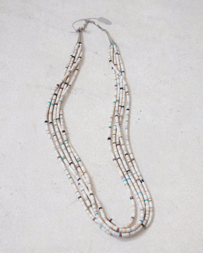 Vintage 5-Strand Santo Domingo Heishi necklace laying on white surface.
